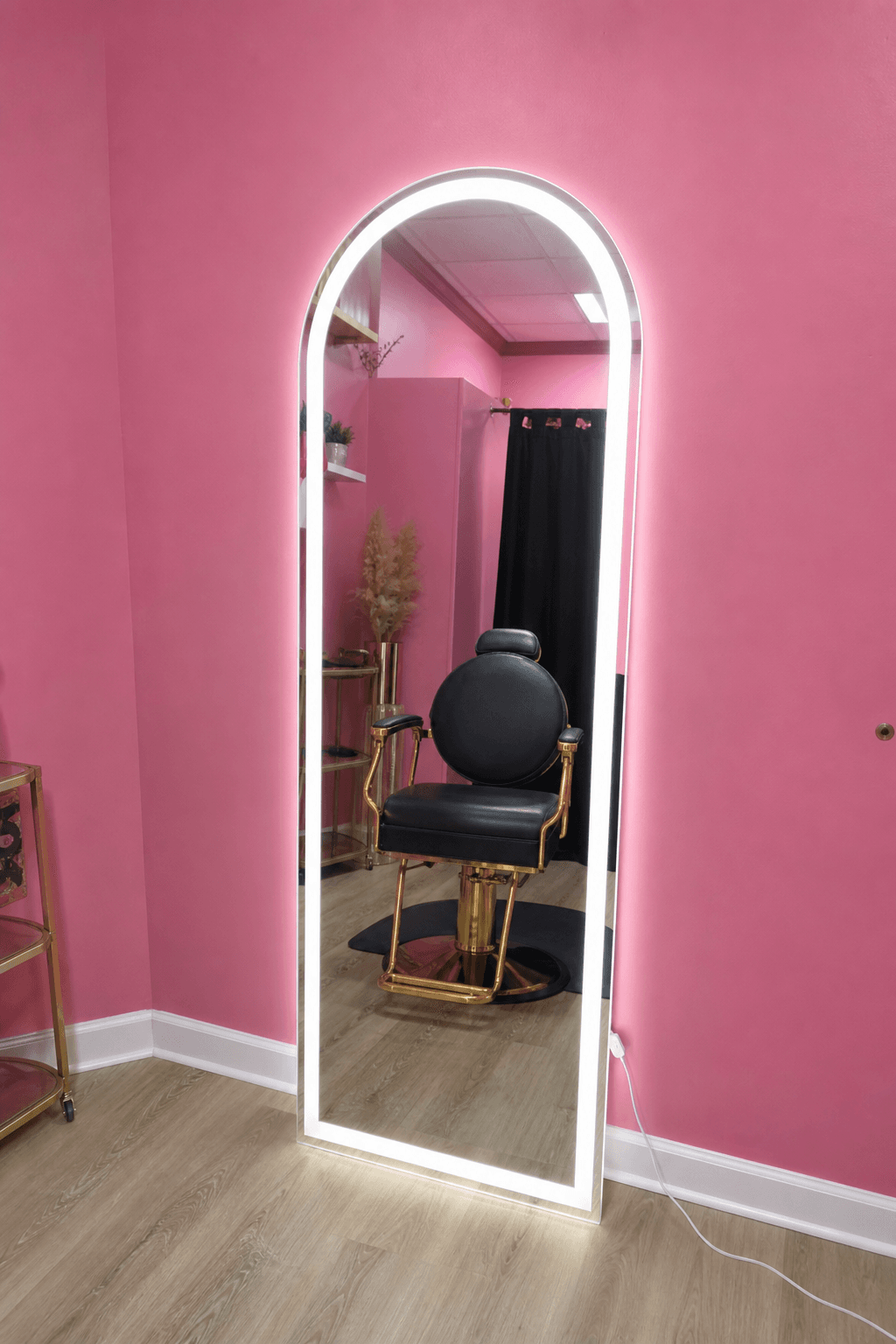 Full-length arched LED mirror in salon suite